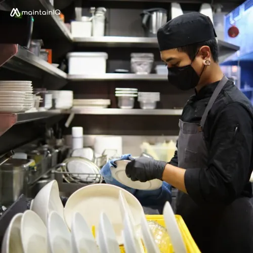 Restaurant staff cleaning and sanitizing surfaces at closing